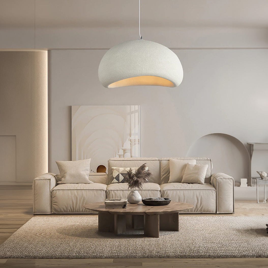 Minimalist chandelier positioned over a living room area, enhancing the space with its elegant design.