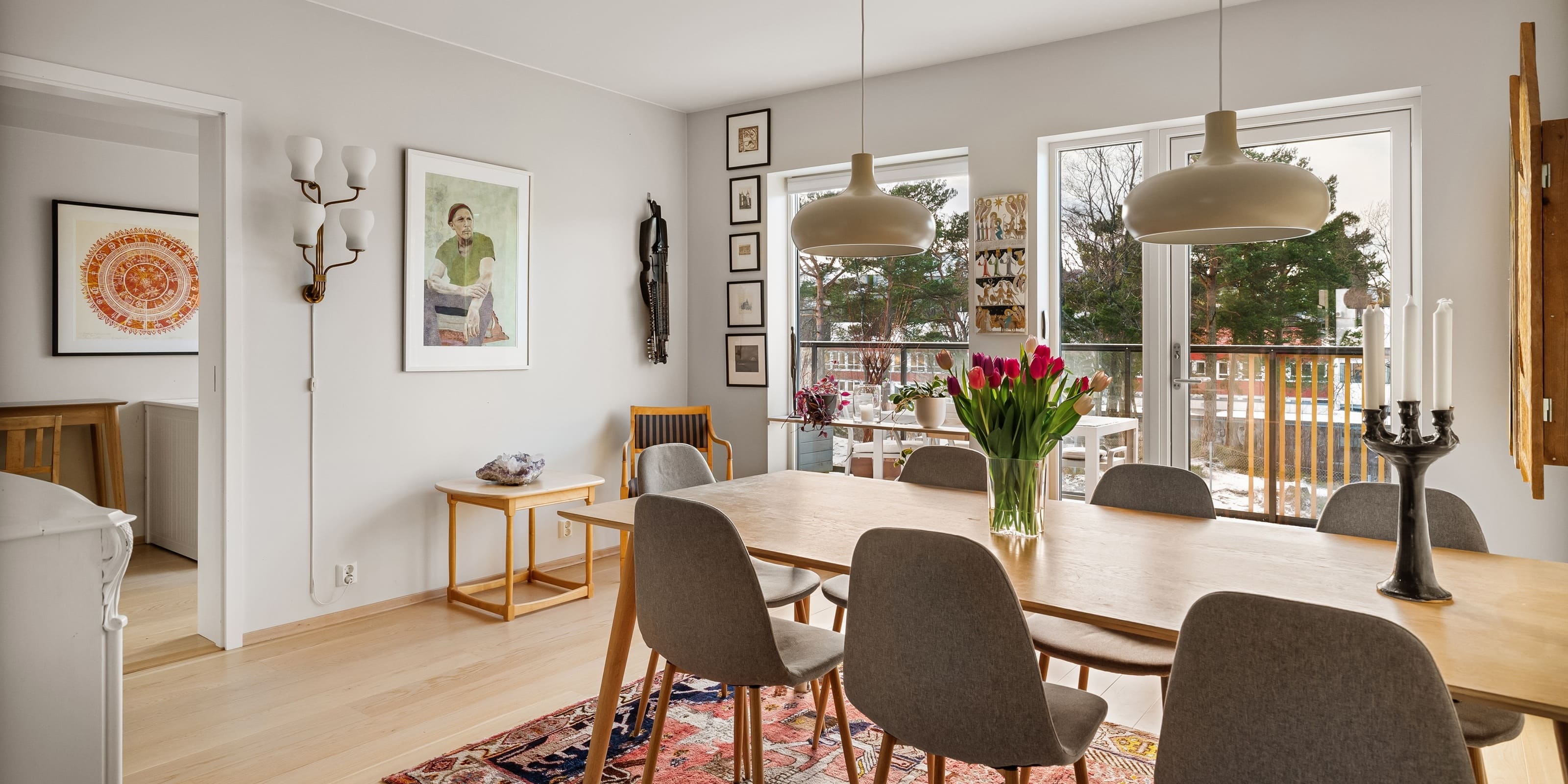 Dining area with modern pendant lights and Scandinavian-style furniture.