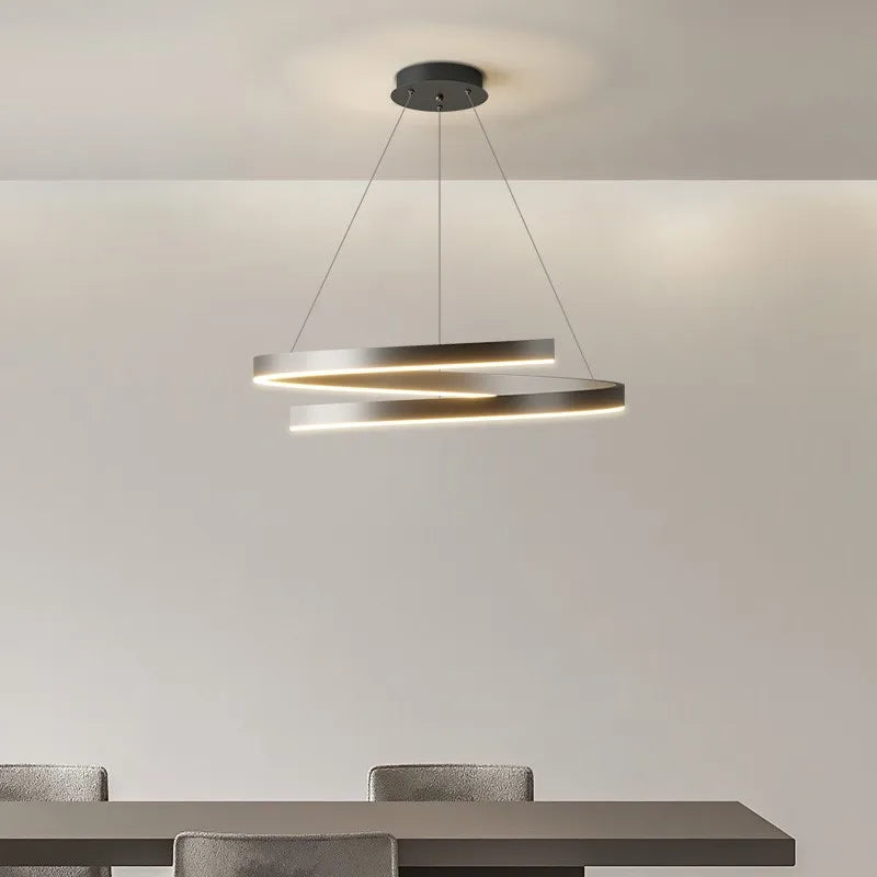 Black modern pendant light with adjustable dimmable LED rings in a dining room