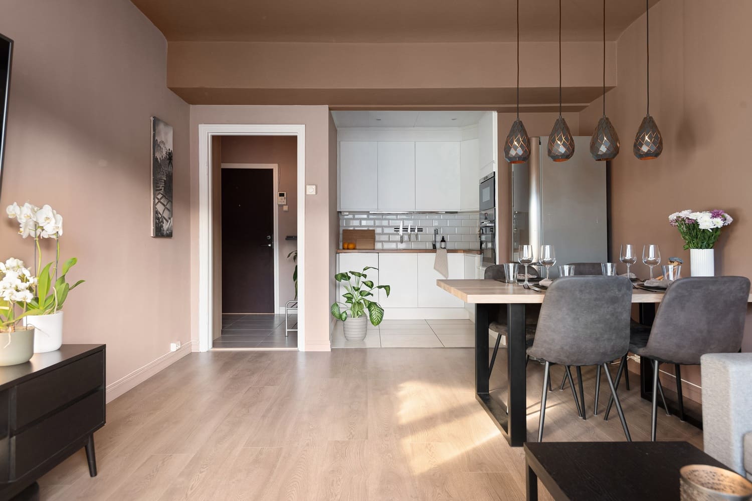 Open dining space with modern pendant lighting and a cozy ambiance.