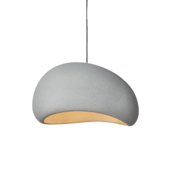 Single minimalist chandelier with a wabi-sabi dome-shaped shade and warm lighting.